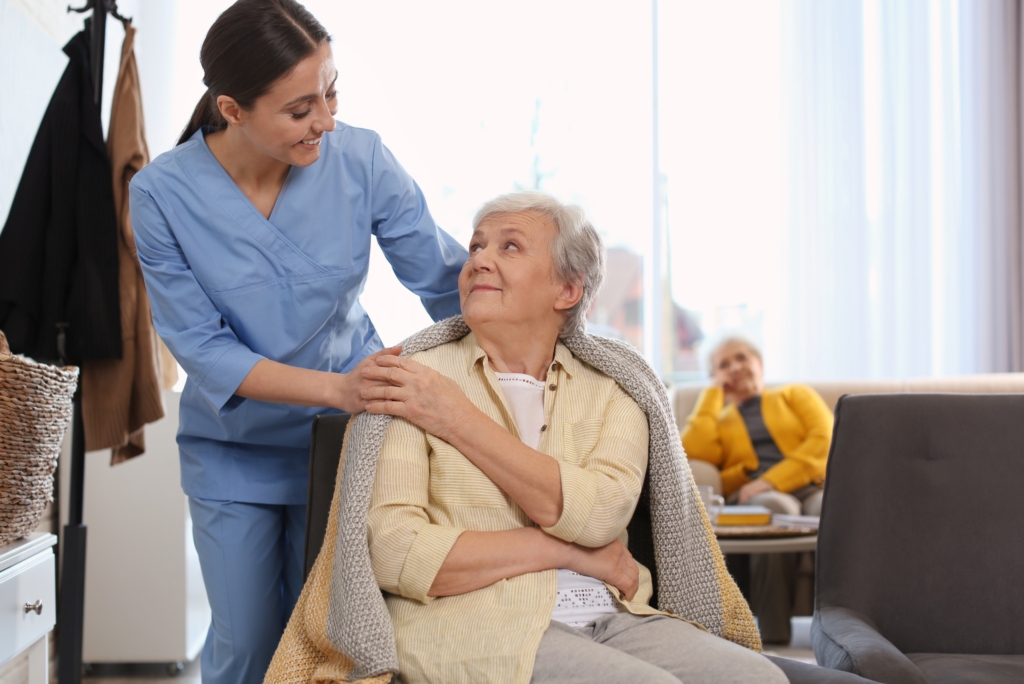 A caregiver provides kindly helps an older client, representing quality home care in West Palm Beach.