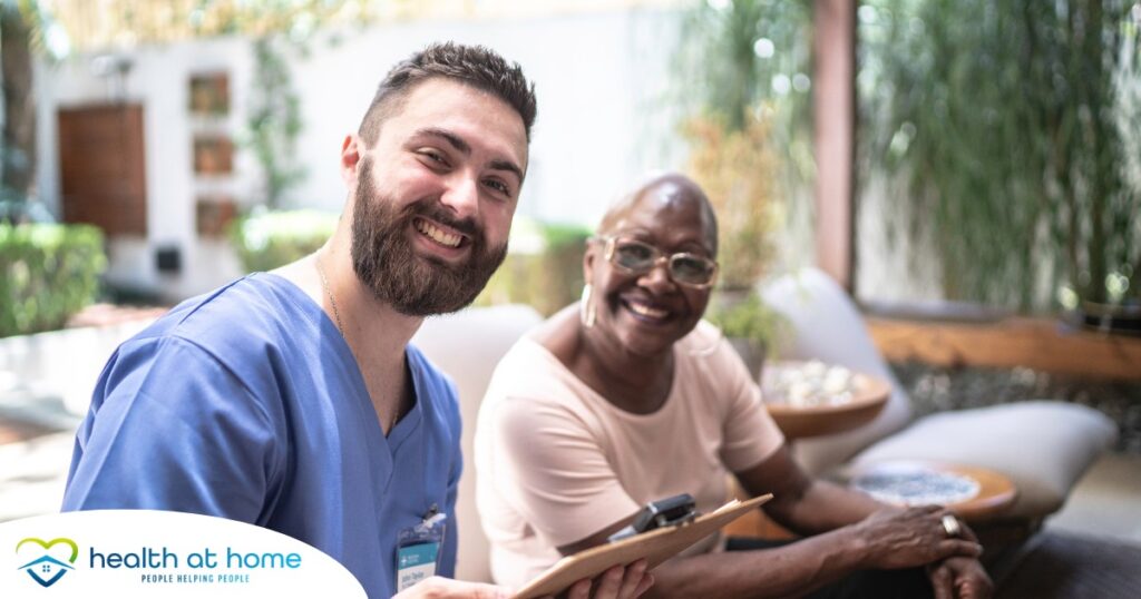 A man enjoys his caregiver job as he works with a client.