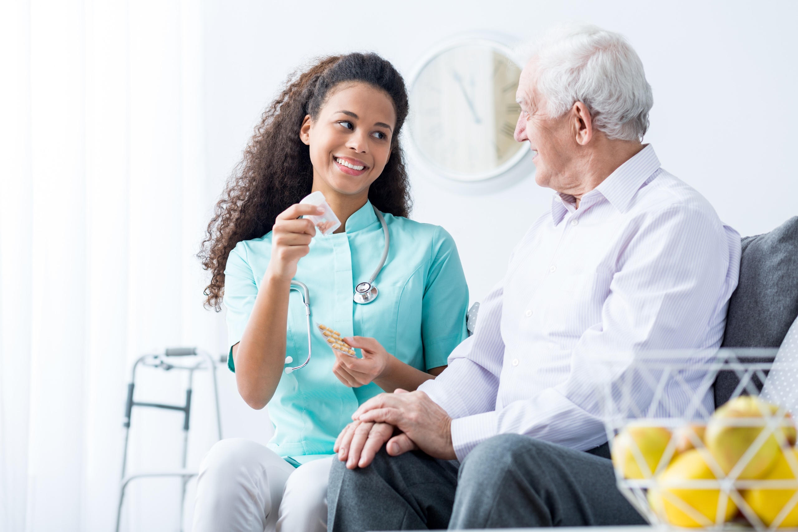 A caregiver helps a patient with their medications, representing how home care in Stuart, FL can help