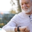 A senior man wears a smart watch, representing one of the many ways smart technology is shaping home health care.