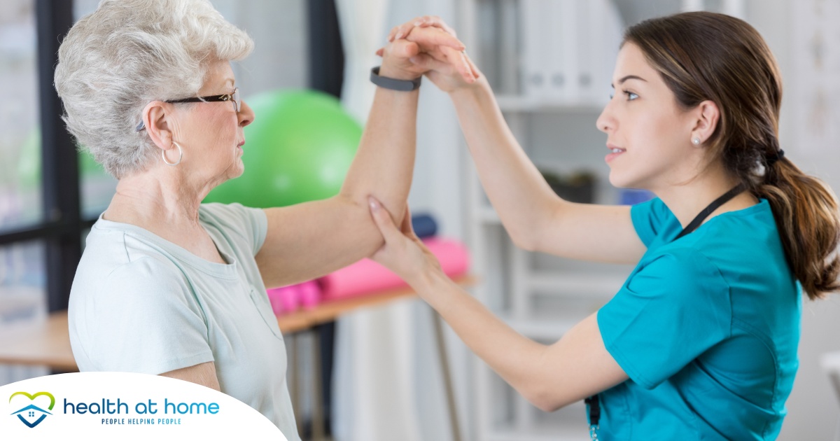 A physical therapist helps a senior patient, representing what National Physical Therapy Month aims to highlight.