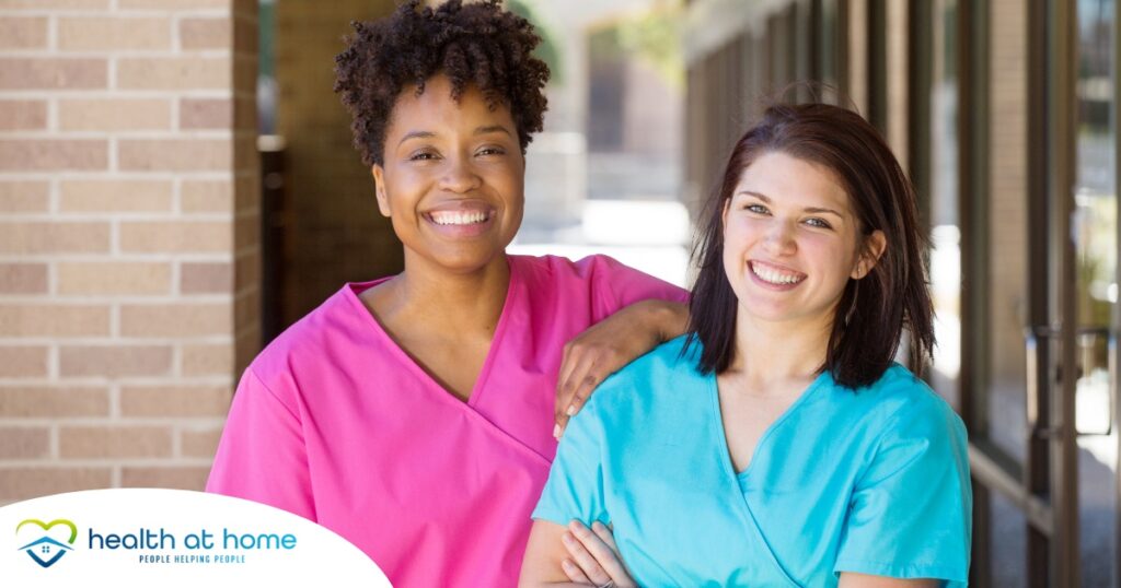 2 smiling women in scrubs represent RN supervisors and the good environment that can be promoted when they work together with caregivers for quality client care.