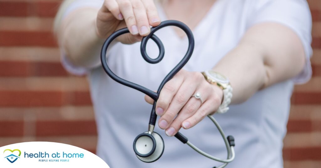 A stethoscope held in a heart represents the self-care that home health workers need to prioritize.