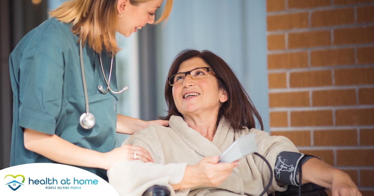 A care provider helps a patient in a wheelchair representing the benefits of medical care at home.