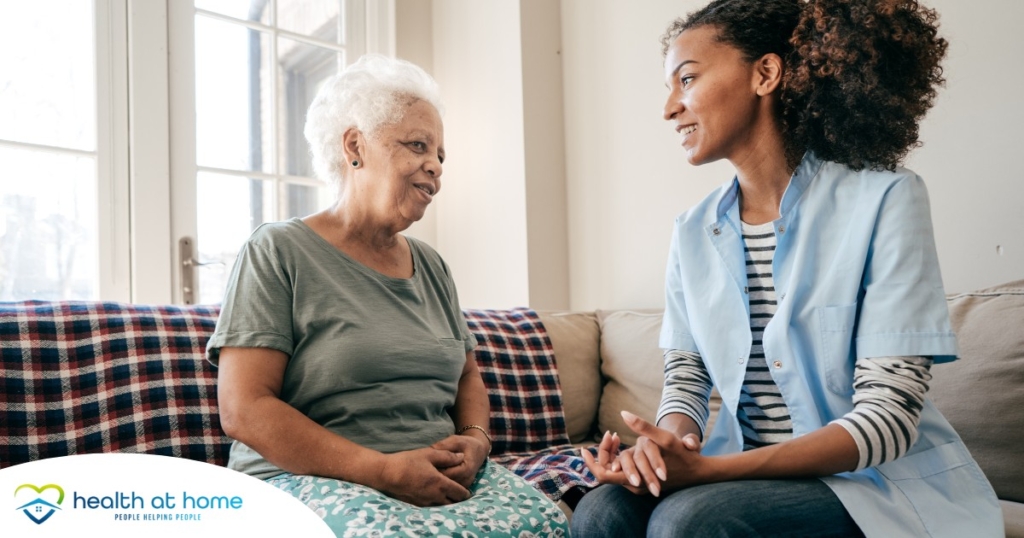 A caregiver sits and spends time with a client, representing how non-medical home care can benefit older loved ones.