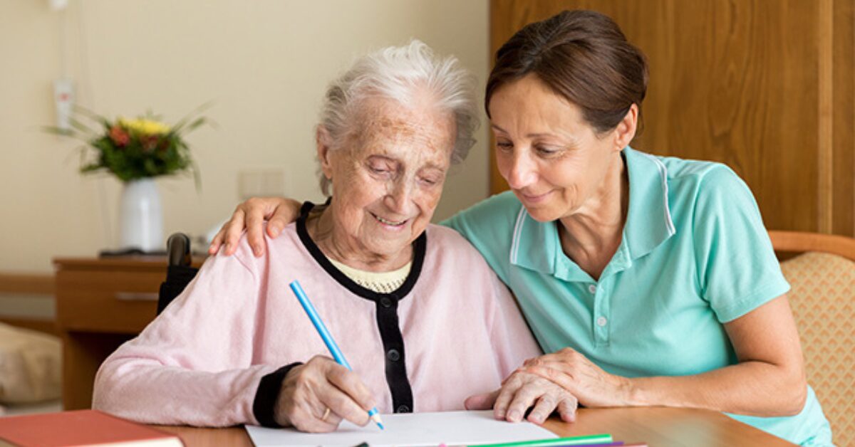 at home dementia caregiver helping client color