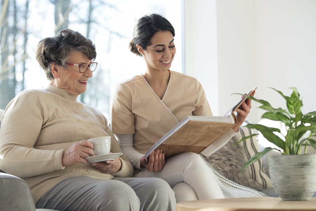 woman sitting with 24 hour home care provider in florida