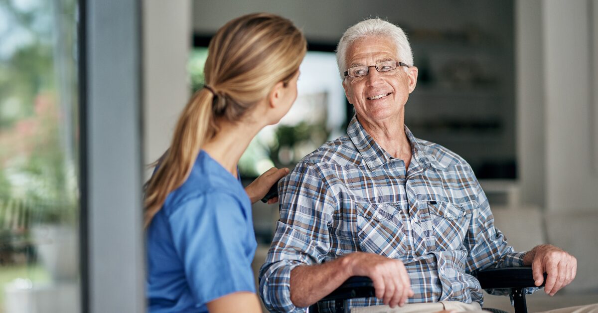 man in wheelchair talking to home health care nurse in Florida