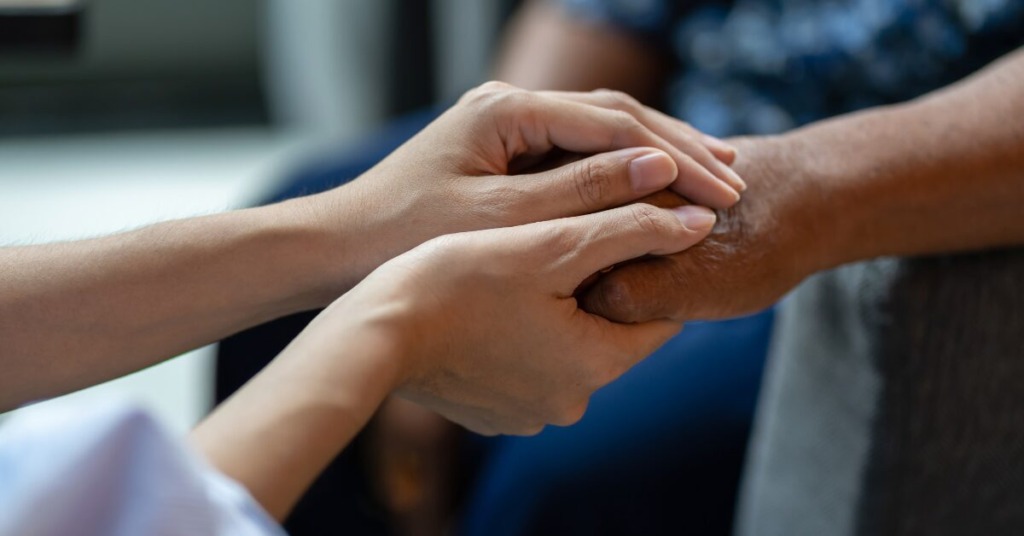 elderly woman being comforted by in-home caregiver in florida