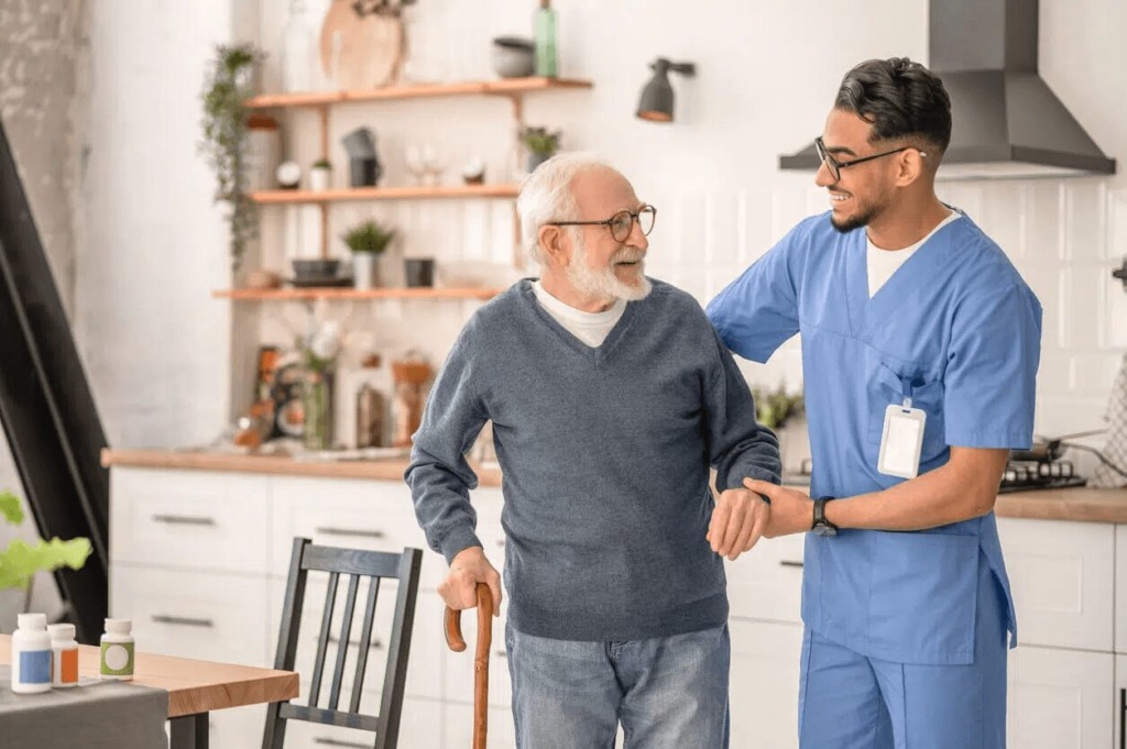 florida home care provider helping elderly man with walking cane