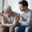elderly man talking to adult child about home care agency in florida