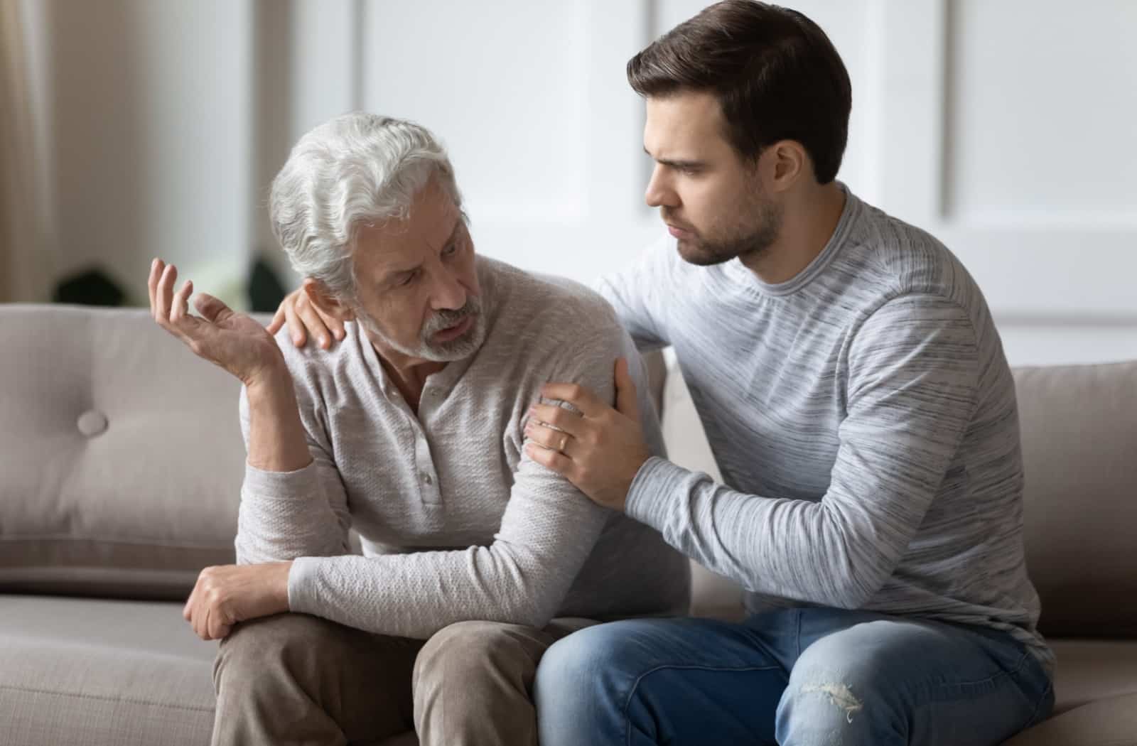 elderly man talking to adult child about home care agency in florida