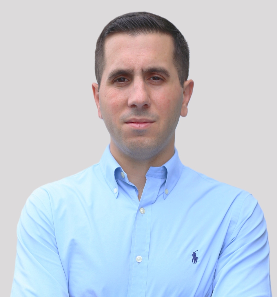 Portrait of a man in a light blue button-down shirt