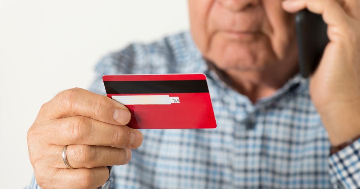 Elderly man on phone with credit card, concerned about finances and congestive heart failure
