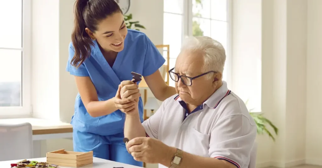 Caregiver assisting senior man with Alzheimer's home care activity