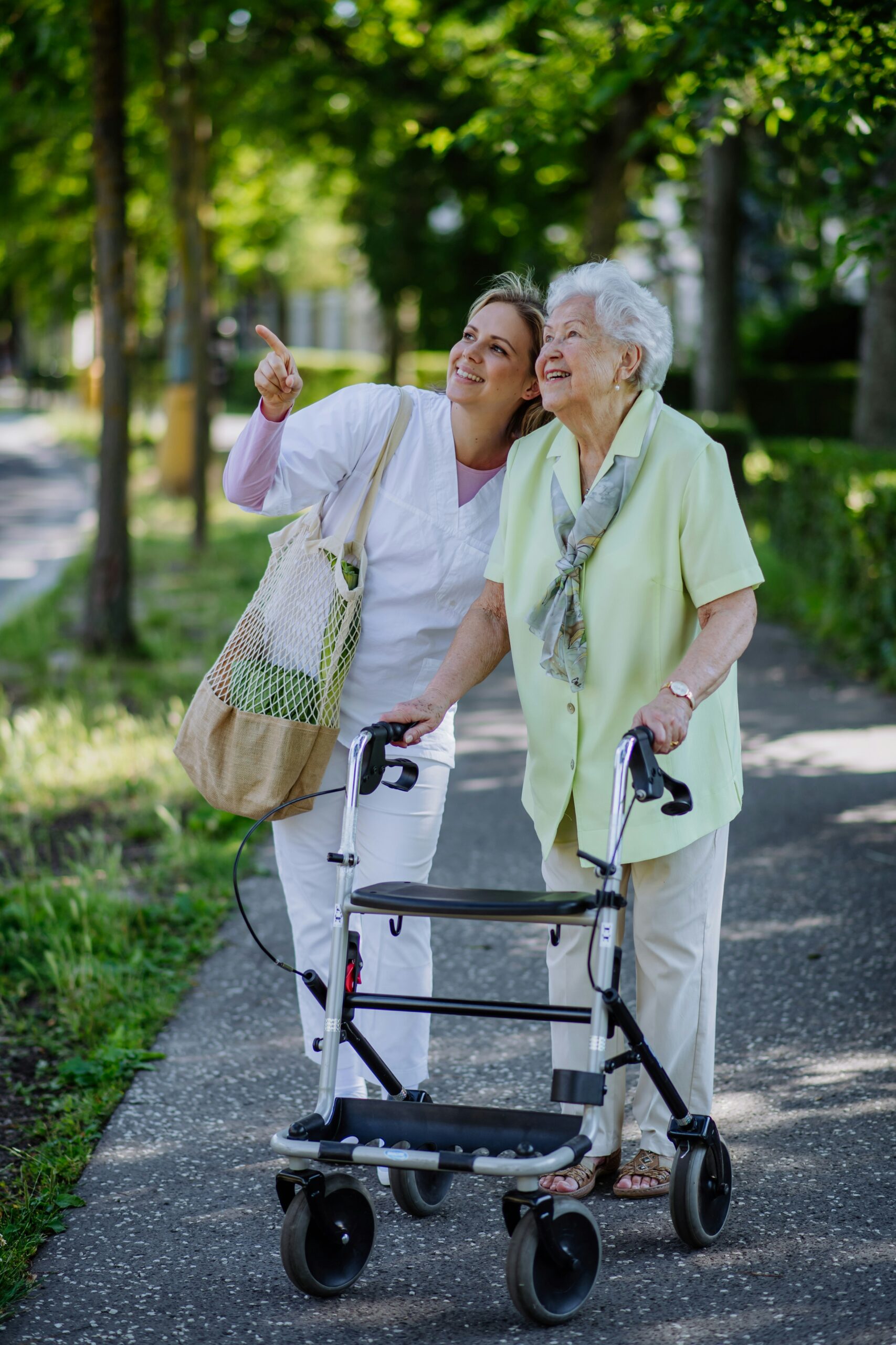 Caregiver and senior woman walking outdoors, Fellsmere home care