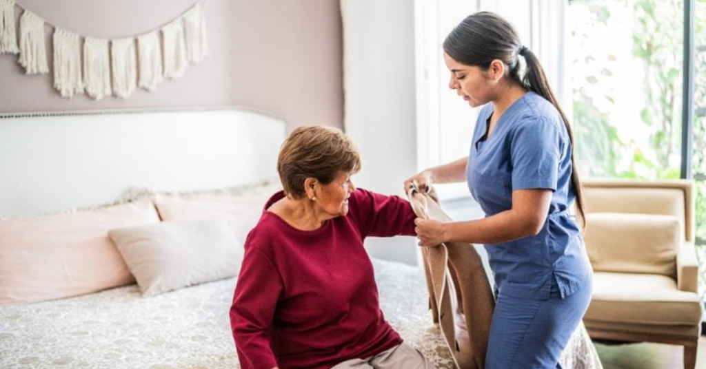 Caregiver assisting elderly woman with Parkinson's care at home.